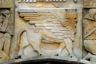 Stone carving of a mythical man-bull with wings