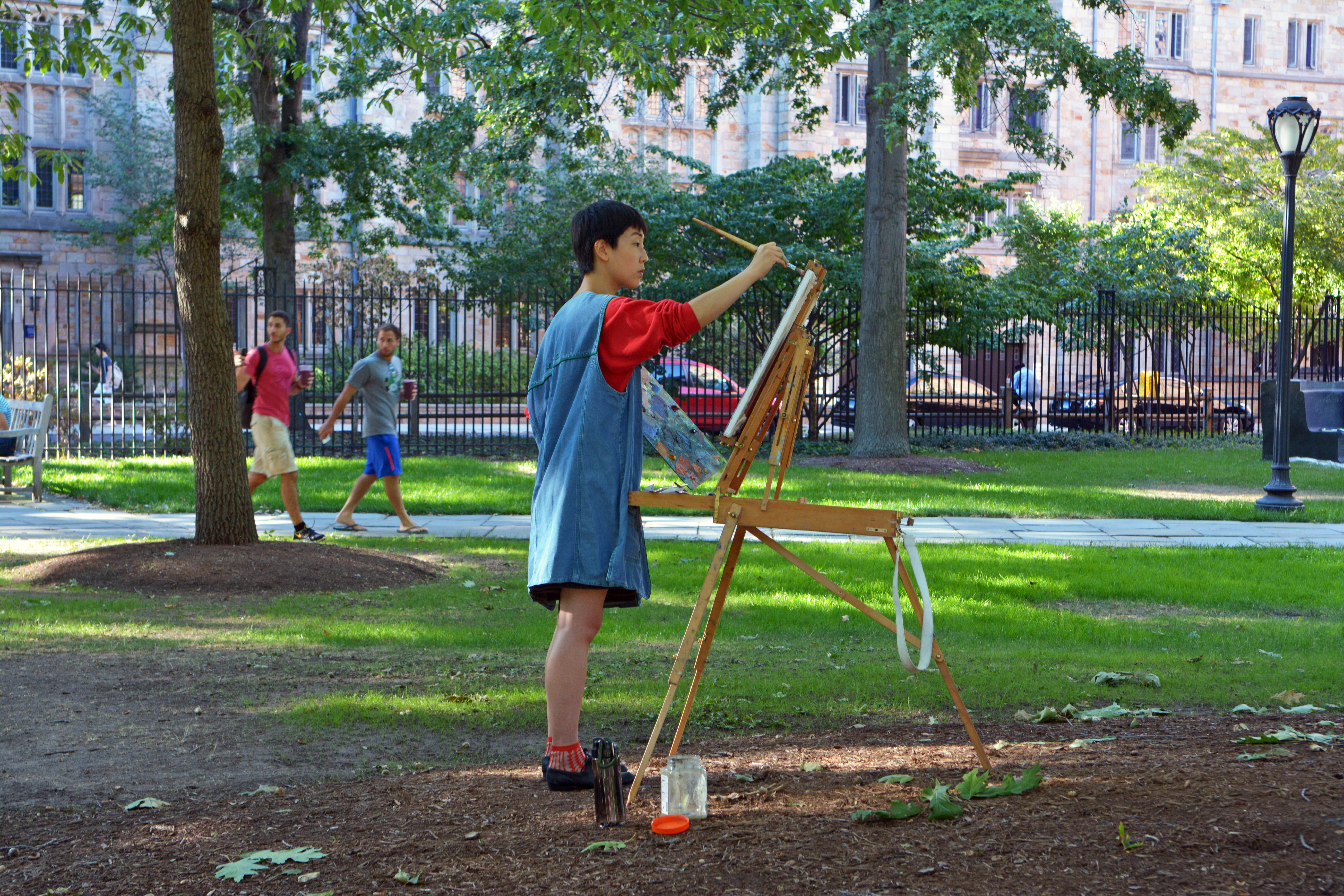 Student painting outdoors