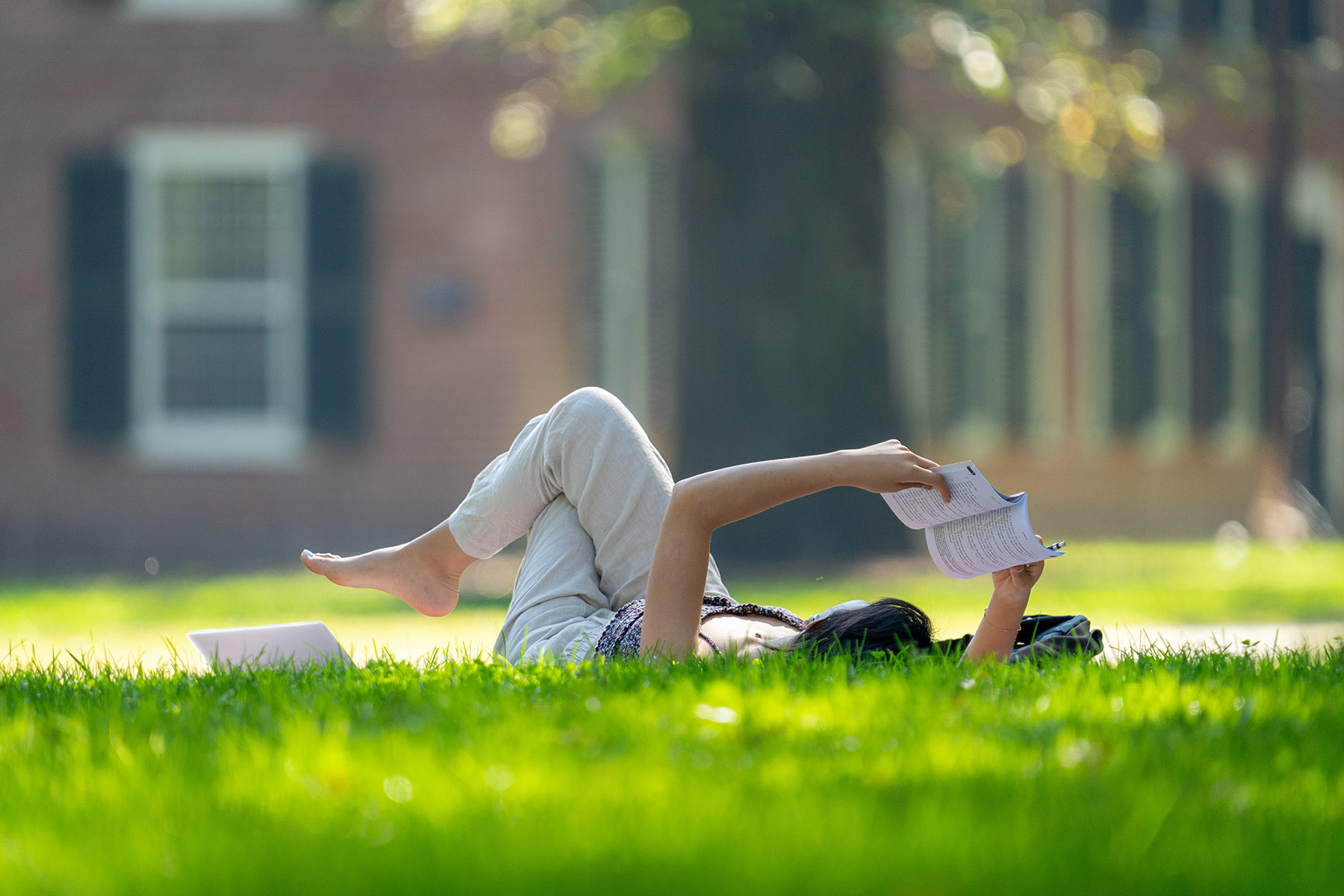 A student reading on old campus