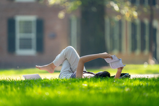 A student reading on old campus