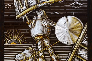 Detailed and dramatic stained glass depiction of Don Quixote
