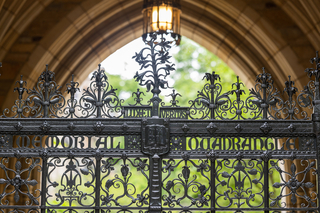 The intricate, wrought iron gate of the Memorial Quadrangle features the Yale motto Lux et Veritas and coat of arms