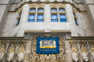 Exterior of Sheffield-Sterling-Strathcona Hall featuring a stone carving of Yale's coat of arms and motto